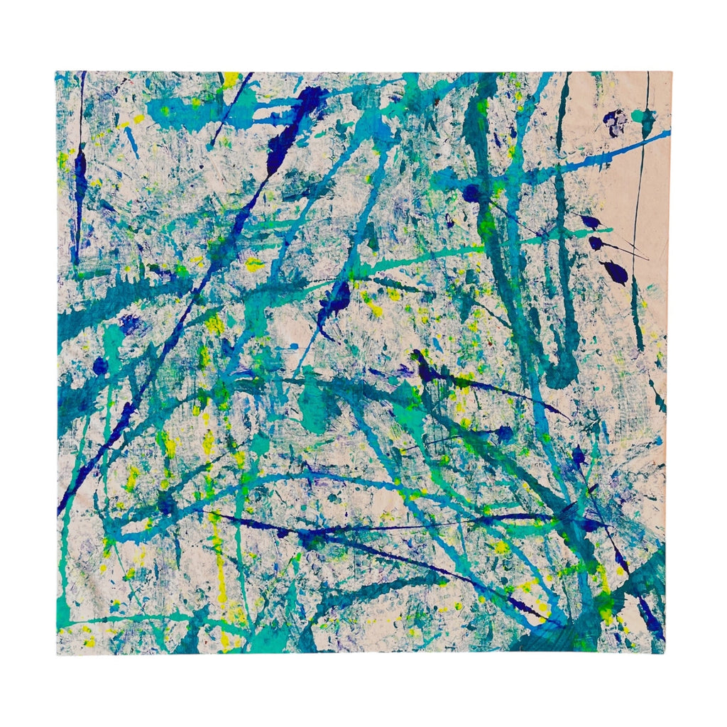 An abstract canvas painting featuring energetic splatters and drips of teal, blue, and lime green paint on a textured off-white background, presented against a solid white studio backdrop.