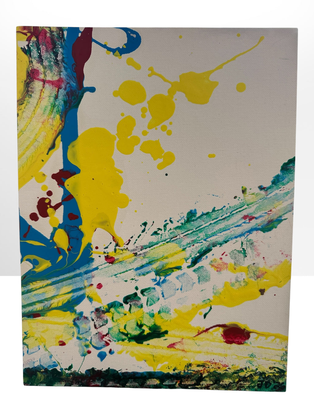 An abstract canvas painting featuring bold splatters and brushstrokes of yellow, blue, green, red, and black paint on a white background.